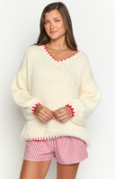 Beginning Boutique Delvey Cream And Red Contrast Stitch Chunky Knit Sweater cream oversized chunky knit sweater with red contrast stitch boat neck and long sleeves