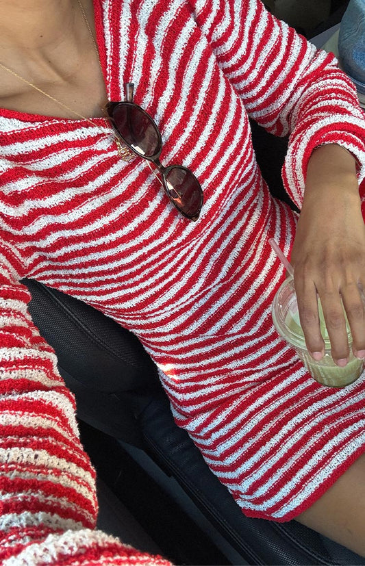 Close-up of a red and white horizontal striped long-sleeve knit mini dress with a boat neckline.
