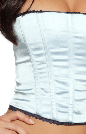 Detail shot of a girl wearing a blue strapless corset showing the paneling and lace edge ideal for a night out