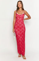 a girl with blonde hair wears a red and white lace maxi dress with gold bracelets and white heels holding a red rose