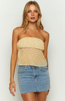 Yellow floral strapless top on brunette model
